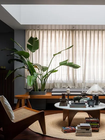 This lounge area features a custom cane armchair and a wooden bench with an integrated planter. I design pieces like these to bring natural textures and greenery indoors, creating small moments of peace and relaxation within the home.
