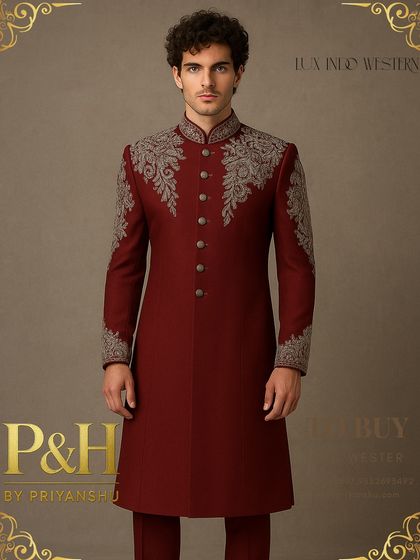 A closer view of the deep red Indo-Western suit, allowing a better appreciation of the texture and detail in the silver hand-embroidery.