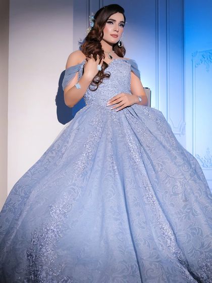 This full-length shot showcases the beautiful drape and volume of my powder blue ball gown. It's a perfect choice for anyone wanting a classic princess look for their engagement or reception.