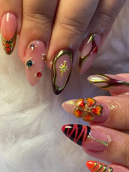 Every nail has its own mood in this eclectic set. We combined animal print, 3D florals, gemstone accents, and chrome details to create a look that is wild, regal, and radiant all at once.