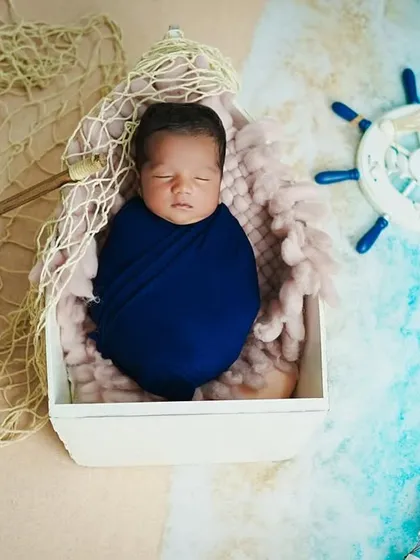 A top-down photograph of the complete nautical setup, showing how all the elements come together to create a cohesive and charming scene for this newborn portrait.