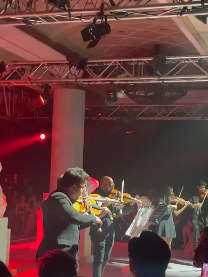 A live orchestra playing at the fashion show, adding another layer of artistry to the event. This reminds me of the various creative elements that need legal consideration.