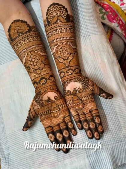 This is a classic, full-hand bridal mehendi that focuses on traditional patterns. It features beautiful peacock figures and complex geometric and floral bands, perfect for a timeless and elegant bridal look.