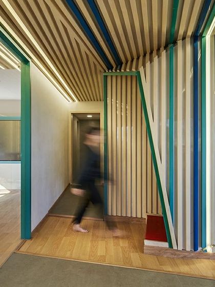 The colorful, banded walls in the Kadence Office create a strong visual identity and guide circulation through the space. This motion-blurred shot captures the energy and flow of the dynamic work environment we designed.