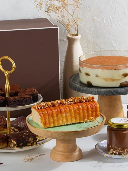 For the ultimate gesture, we offer fully customizable dessert hampers. This large hamper includes a variety of our signature items: a Classic Tiramisu bowl, a Vanilla Salted Caramel Loaf cake, an assortment of our dessert bars, and two mini dessert jars, all beautifully arranged for gifting.