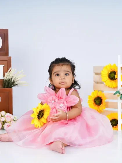 A lovely first birthday shoot with a sunflower and pink dress theme. The combination of bright yellow and soft pink creates a beautiful contrast.