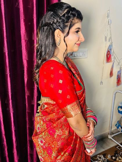 A side view of the Roka bride, showing the beautiful braided and curled hairstyle.