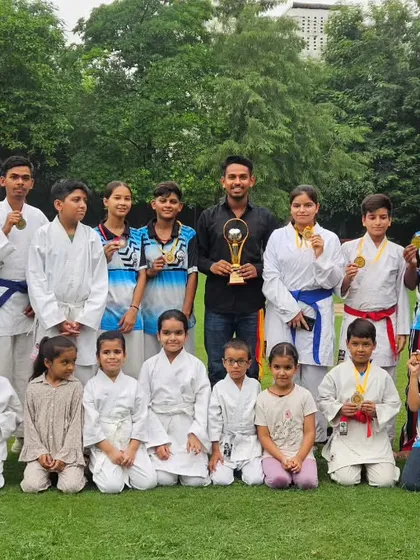 Our family of fighters after a successful championship. We stand together with our medals and trophies, a testament to the effort we put in day after day.