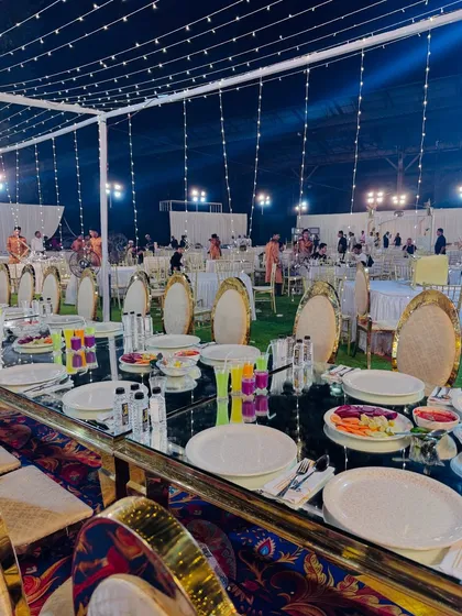 The mirrored tables reflect the lights and decor, adding to the glamorous and festive atmosphere of the wedding.