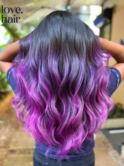 We call this the "molly melt." A beautiful balayage of purple and pink tones that melt together seamlessly on long, dark hair.