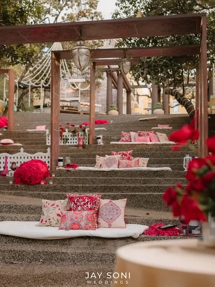 A beautifully composed shot of the tiered seating, with a vibrant red rose arrangement in the foreground, adding a touch of romance to the scene.