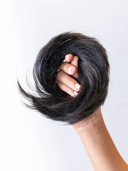This is the Donut Bun extension, made from 100% real human hair. It's the secret to creating a full, perfectly shaped bun, whether you want a sleek or messy style.