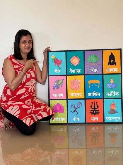 Pointing to the details on the large, custom-sized Marathi calendar. I love working on big pieces that become the centerpiece of a room.