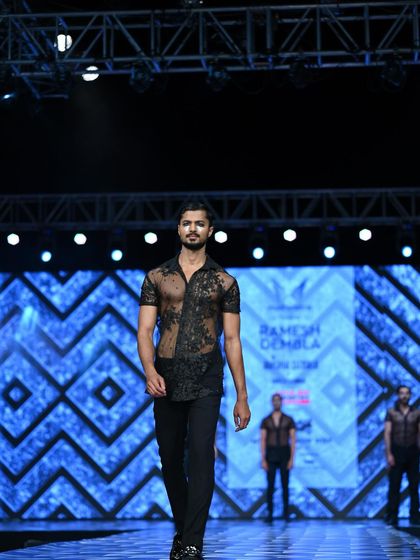 Walking with purpose down the runway for Ramesh Dembla. Each step is calculated to best display the designer's creation.