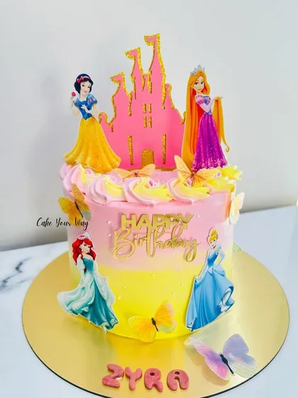 A fairytale castle cake for Princess Zyra. The pink and yellow ombre effect with princess and butterfly toppers makes it a truly magical creation.