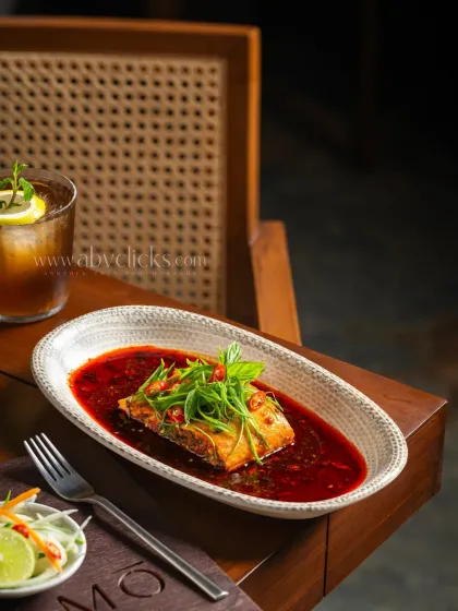 A pan-seared fish in a rich, red Asian-style sauce from Camo, Noida.