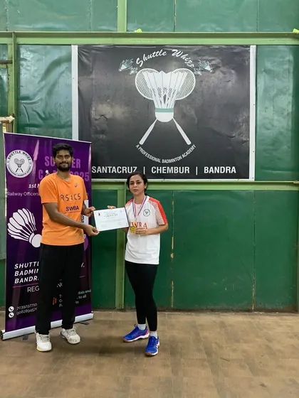 A player from our Bandra West academy proudly displays her medal and certificate. We ensure every student receives recognition for their hard work and participation.