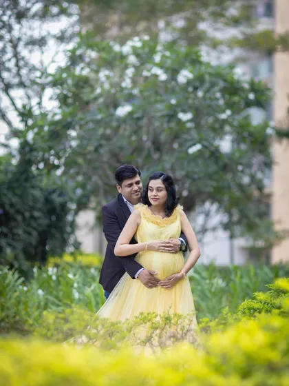 An embrace from behind is a classic and loving pose that beautifully frames the baby bump and the connection between the couple.