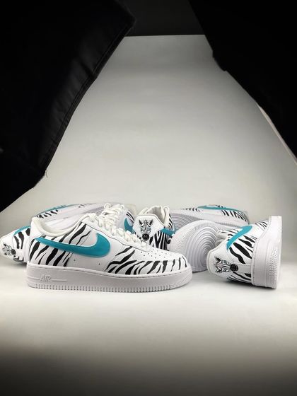 The zebra stripe custom sneakers in a studio lighting setup.
