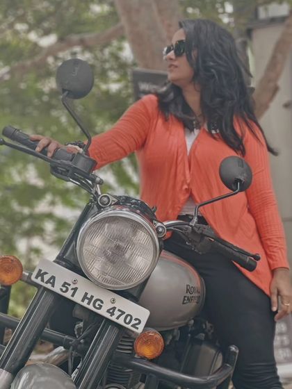A graduate poses with her Royal Enfield, looking stylish and confident. She is a true inspiration to other aspiring women riders.