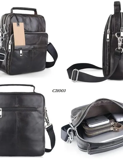 An overview of our compact leather messenger bag, model C21003. This bag features a top handle and a detachable crossbody strap, with multiple zippered compartments designed to securely organize electronics and documents.