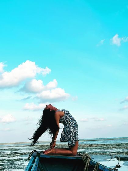 Yoga hairs, don't care! A joyful Ustrasana (Camel Pose) on a boat, opening my heart to the sky and the sea.