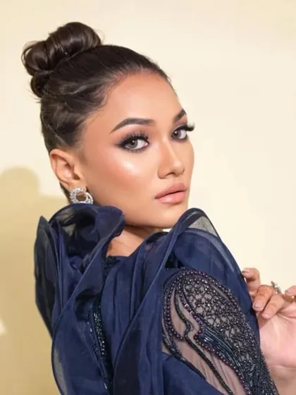A profile view highlighting the texture of the side braids leading into the high bun. It's a subtle detail that elevates the entire hairstyle.