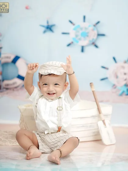 Hands up if you're having fun. This joyful shot perfectly captures the spirit of the sailor-themed photoshoot.
