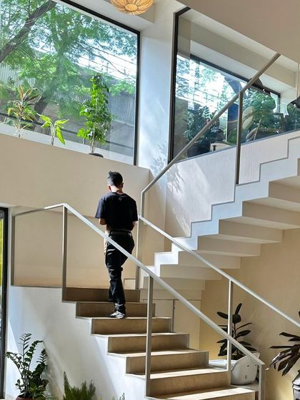 Taking the stairs at our Indiranagar cafe. The large windows bring the outside in, connecting the space with nature.