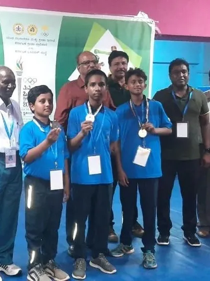 Our junior boy's team posing with their medals and officials after the competition. Their success is a result of consistent effort in our youth boxing program.