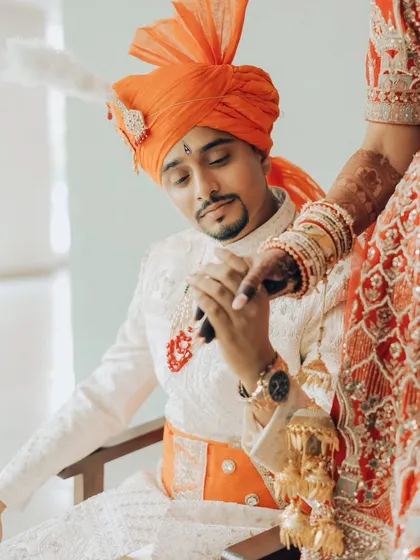 The gentle touch, the quiet admiration. This close-up shot focuses on the tender connection between the couple, a beautiful detail from their love story.