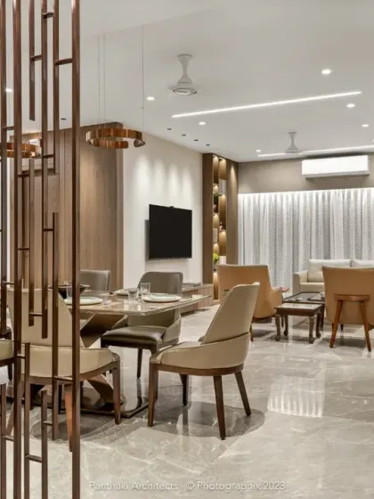 We used a custom-designed wooden screen to create a sense of entry and separation for the dining area while maintaining the open feel of the living space. This detail adds architectural interest and defines the different functional zones.