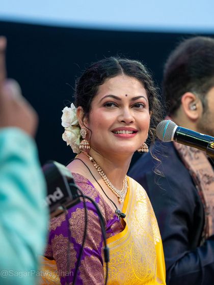 Another lovely candid of Priyanka Barve during her concert, showcasing the pearl jewelry and traditional styling.