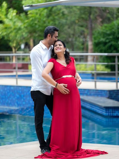 A classic, romantic couple portrait by the pool. The love and anticipation are beautifully captured as the dad-to-be embraces his partner from behind.