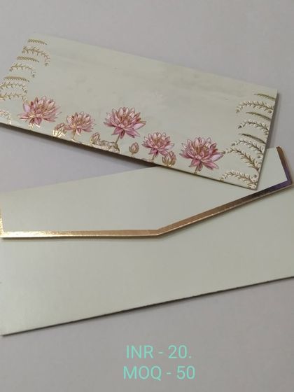 An elegant off-white money envelope with a simple design of pink lotus flowers and gold foil accents. The look is clean, modern, and sophisticated.