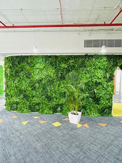 For a modern and maintenance-free green look, I install artificial vertical gardens. This large green wall was created for an office interior, bringing life to the space without needing soil or water.