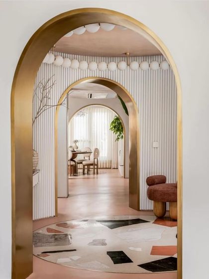 The grand entrance of the "Marshmallow" penthouse, featured by FOAID, with its layered arches and custom terrazzo flooring.