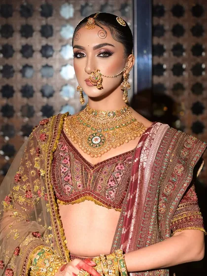 A powerful, direct gaze. This close-up highlights the sharp, defined eye makeup that gives this bridal look its regal and confident feel.