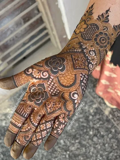 The full palm view of a semi-bridal design, with a mix of bold and fine lines.