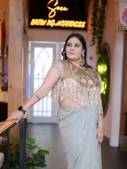 Another angle from the outfit photoshoot, showcasing the elegant makeup and the stunning designer ensemble.