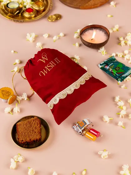 My modern take on a timeless tradition, the "Thamboolam Tales" potli. It’s filled with thoughtful items like a coconut candle, paan-flavored chocolates, and a mini Ganesha holder, making it a memorable wedding favor for guests.
