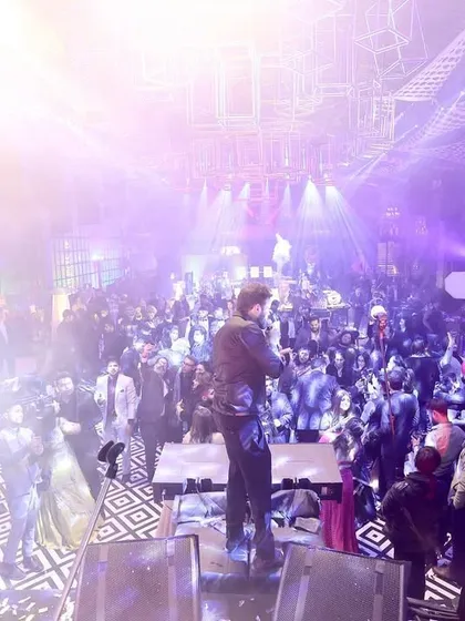 A wide shot showing the scale of a concert-style Sangeet party.