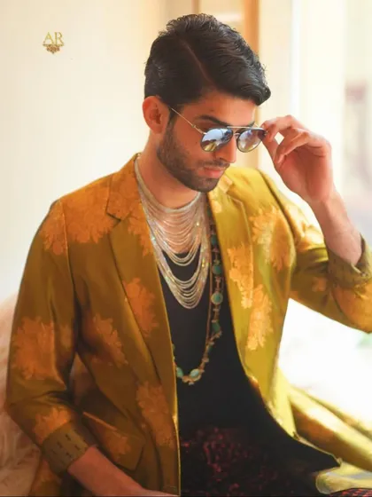 For me, men's styling has no boundaries. I created this look with a mustard gold brocade overcoat and silk velvet tie-dye pants to show that luxury menswear is all about confident layering and breaking the rules.