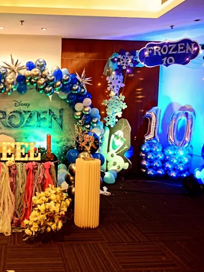 A grand Frozen-themed 10th birthday party for Princess Zeel. This setup includes a custom backdrop, character cutouts, themed table skirting, and marquee letters, creating a complete winter wonderland.