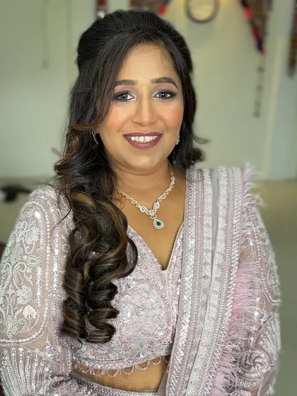 A smiling portrait. The client looks radiant and ready for her event.