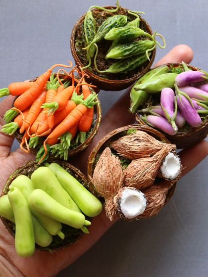 A handful of my miniature vegetable baskets, including carrots, brinjal, and coconuts.