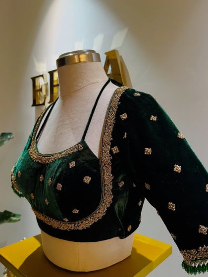 This bottle green velvet blouse is designed to elevate your curves. The simple yet elegant hand embroidery in silver adds a touch of sparkle, while the structured cut ensures a flattering fit with any saree or lehenga.