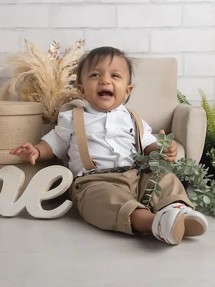 A big, happy laugh from the birthday boy! This little man is celebrating his first birthday with a stylish, rustic-themed cake smash session in the studio.