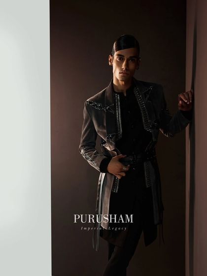 Eternal elegance triumphs. This dark, belted jacket with its subtle shimmer and modern cut is a testament to the power of a well-crafted silhouette.