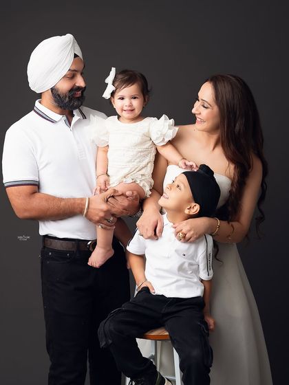 So much love and happiness in one frame. This family portrait is full of interaction and smiles, showing the beautiful bond between parents and their two children.